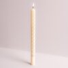 Ivory coloured advent candle with the numbers 1 to 24 down the candle. Text at the bottom reads Happy Christmas.