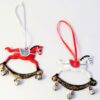 Tin Rocking Horse Tree Decorations in two different colours - red or white. The decorations have ribbon hanging loops and bells on the bottom.