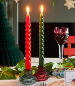 Two deluxe dinner candles, one is red, one is green.