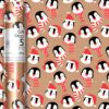 Brown kraft wrapping paper decorated with penguins wearing santa hats and woolly scarfs.