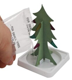 A hand pours liquid on the magic tree.