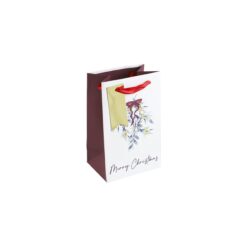 Small gift bag with mistletoe design and text Merry Christmas. Red ribbon handles and gold gift tag.