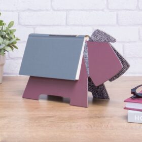 Purple coloured Doggy Book Rest with a book resting over the top.