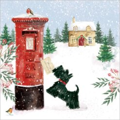 A Scottie dog puts its paws up against a red post box which has a robin perched on top. A cosy cottage sits in the background Snow falls heavily all around.