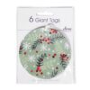 6 giant tags by Deva Designs. Round tags with white ribbons with an image of green and black festive foliage and red berries. Decorated with white snowflakes.