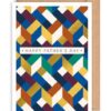 Father's Day card with brown envelope. Card has a geometric style pattern in blues, greens, whites and brown. Text on the front reads Happy Father's Day.