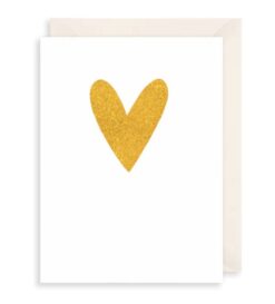 A white card with a gold heart on the front.
