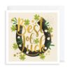Good luck card featuring an illustration of a horseshoe decorated with four leaf clovers. Text on the front reads 'Best of Luck' in gold letters.