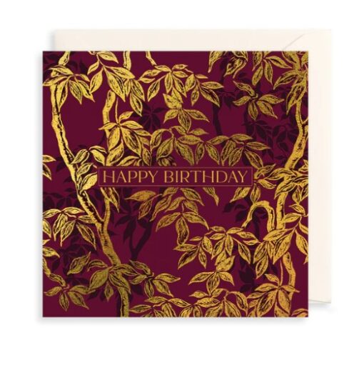 Maroon card with gold tree design and the text Happy Birthday in the centre in uppercase letters.