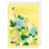 Yellow Mother's Day card with bright flowers and butterflies. Text on the front reads with love on Mothering Sunday.