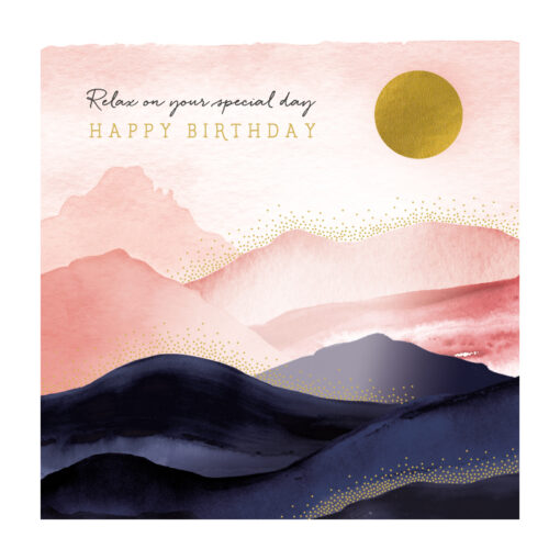 Birthday card with a watercolour illustration of mountains which is pale pink in the background and navy in the foreground. There is a golden sun in the top corner. Text reads 'Relax on your special day. Happy Birthday'.