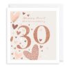 Pearl anniversary card. A large pink 30 appears in the centre with the text Happy Pearl Anniversary at the top. The card is decorated with pink, white and red hearts.
