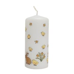 White pillar Easter candle decorated with yellow chicks, daffodils and bunnies.