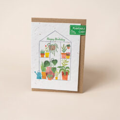 A plantable birthday card with an illustration of a greenhouse which contains colourful pots, plants and flowers. Text on the front reads Happy Birthday.