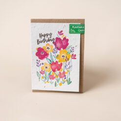 Plantable card with colourful watercolour illustration of flowers. The text reads Happy Birthday.