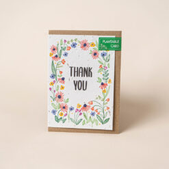 Plantable card with the text Thank You in the centre, surrounded by colourful flowers.