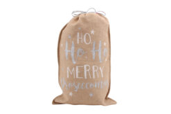 A hessian Christmas gift sack with the text Ho Ho Ho Merry Proseccomas in blue and white letters.