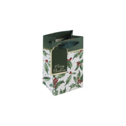 Small Christmas gift bag with holly design on a white background, green ribbon handles and gold and green tag.