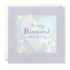 Square card with a pale purple heart in the centre which has the text Happy Diamond Anniversary. A clear window on the front of the card is filled with paper heart confetti.