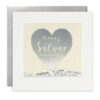 Square card featuring a window full of silver glitter and sequins, with a silver heart painted on the front. The text reads ‘Happy Silver Anniversary’.