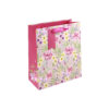 Pink floral gift bag with pink tag and pink ribbon handles.
