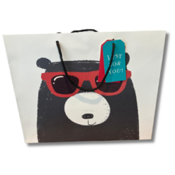 White gift bag with an illustration of a black bear wearing red sunglasses.