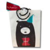 White Gift bag with an illustration of a black bear wearing a blue party hat and holding a red gift.