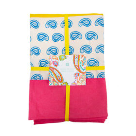 Cotton boho table cloth folded and wrapped with yellow ribbon.