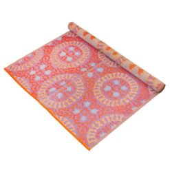 Waterproof rug in pink, orange and purple geometric patterns.