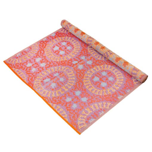 Waterproof rug in pink, orange and purple geometric patterns.