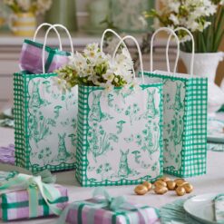 Green and white paper gift bags with rabbit illustrations.