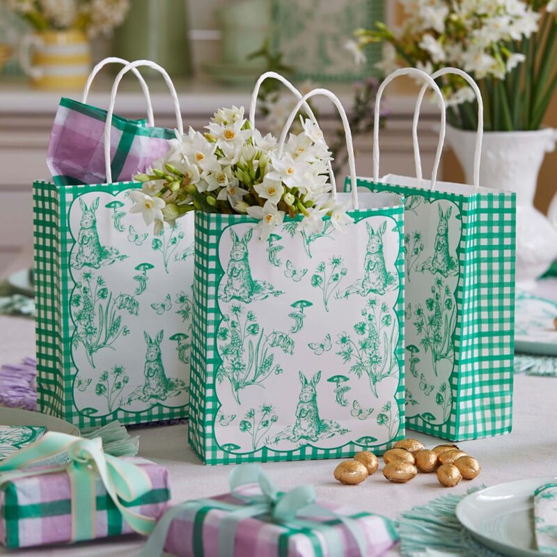 Green and white paper gift bags with rabbit illustrations.