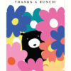 Greetings card with an illustration of a black bear poking it's head through a wall of big colourful flowers. Text at the top reads 'Thanks a Bunch!'.