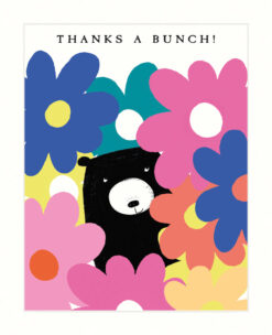 Greetings card with an illustration of a black bear poking it's head through a wall of big colourful flowers. Text at the top reads 'Thanks a Bunch!'.