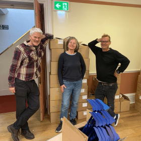 Staff and volunteers in a Cards for Good Causes pop up Christmas shop.