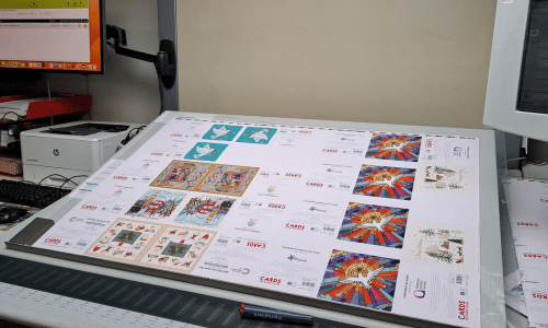 Photograph of Cards for Good Causes charity Christmas cards being prepared for printing.