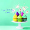 Birthday card with a blue background. Five cupcakes with different coloured icing sit on a white cake stand. They each have a sparkler in the top. Text on the card reads 'Happy Birthday to you!'.