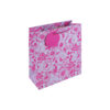 Gift bag with bright pink floral design. The bag has pink handles and a round pink gift tag.