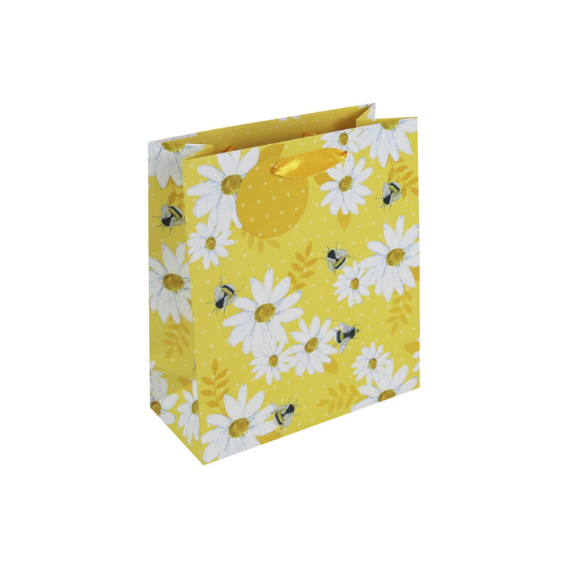Yellow medium sized gift bag with white and yellow daisies and little bees. The bag has yellow handles and a round yellow gift tag with white dots.
