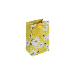 Yellow small sized gift bag with white and yellow daisies and little bees. The bag has yellow handles and a round yellow gift tag with white dots.