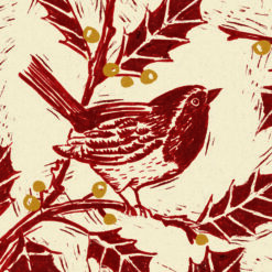 Christmas card with a lino cut printed image of a robin in a holly bush