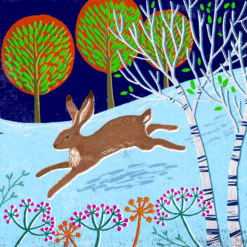 Christmas card featuring a hare leaping in a winter forest