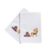 Two white napkins embroidered with a reindeer pulling a sleigh piled high with gifts.
