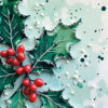 Christmas card with a close up image of holly with red berries laid on snow