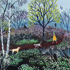 Christmas card with an image of a woman and two dogs walking through a winter forest