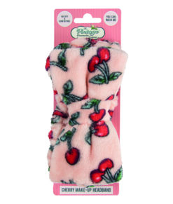 A soft fabric head band which is pink with a red cherry pattern. Text on the cardboard packaging reads 'I'm soft and comfortable' and 'You can Wash Me'.