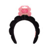A croissant shaped head band in black velvet material from The Vintage Cosmetic Company.