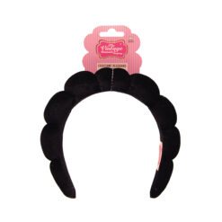 A croissant shaped head band in black velvet material from The Vintage Cosmetic Company.