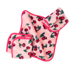 Three pink make up removing cloths with a red cherry pattern. The cloths have a red border on them.