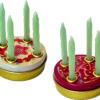 Two small round tins with festive designs and 4 small holes on the lid. Each hole has a mini candle standing in it.